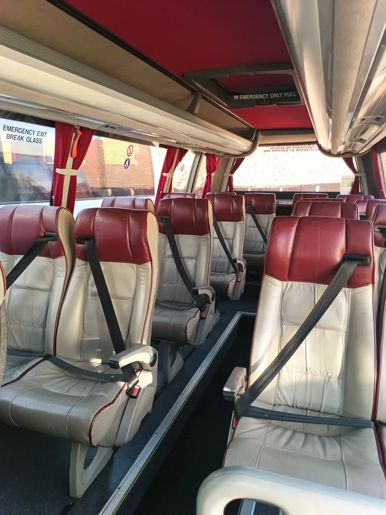 Inside an 18 seat minibus, leather seats with belts fitted throughout